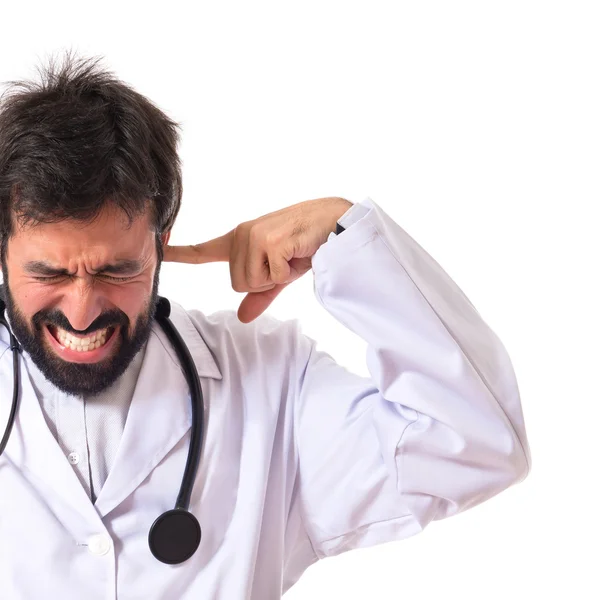 Doctor covering his ears over white background — Stock Photo, Image
