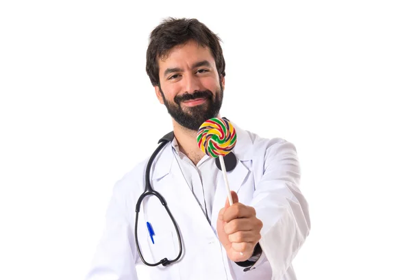 Doctor with lolly pop over white background — Stock Photo, Image