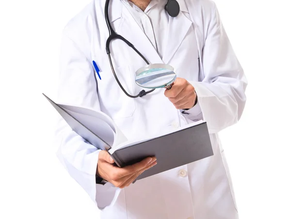 Doctor reading a book over white background — Stock Photo, Image