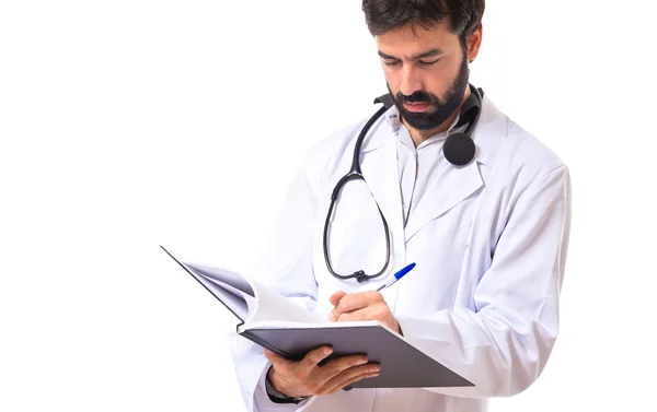 Doctor reading a book over white background — Stock Photo, Image