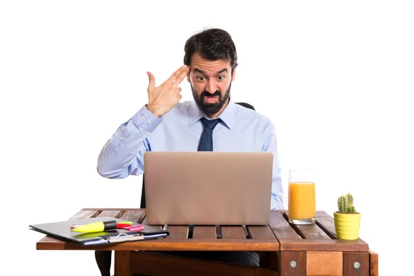 Businessman in his office making suicide gesture — Stock Photo, Image