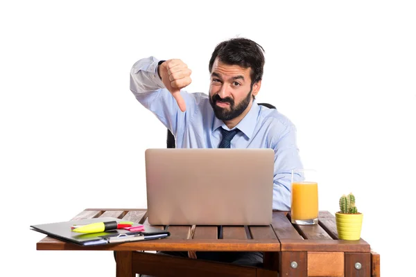 Businessman in his office  doing a bad signal — Stock Photo, Image