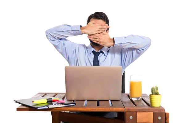 Businessman in his office covering his face — Stock Photo, Image