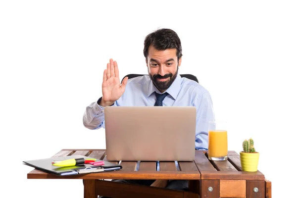 Businessman in his office saluting somebody — Stock Photo, Image