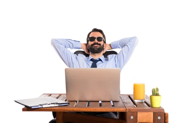 Businessman in his office with sunglasses — Stock Photo, Image