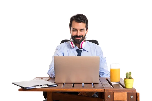 Businessman in his office listening music — Stock Photo, Image