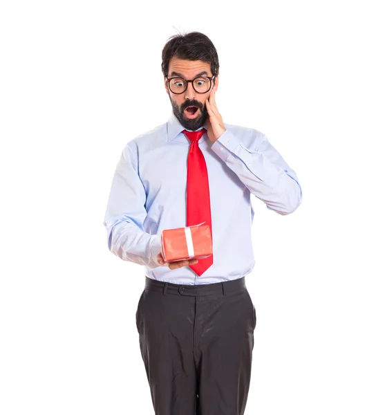 Businessman with gift over white — Stock Photo, Image