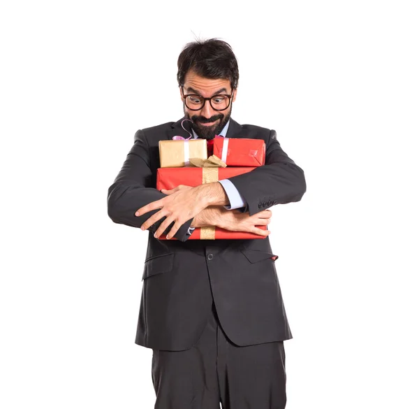 Businessman with several gifts — Stock Photo, Image