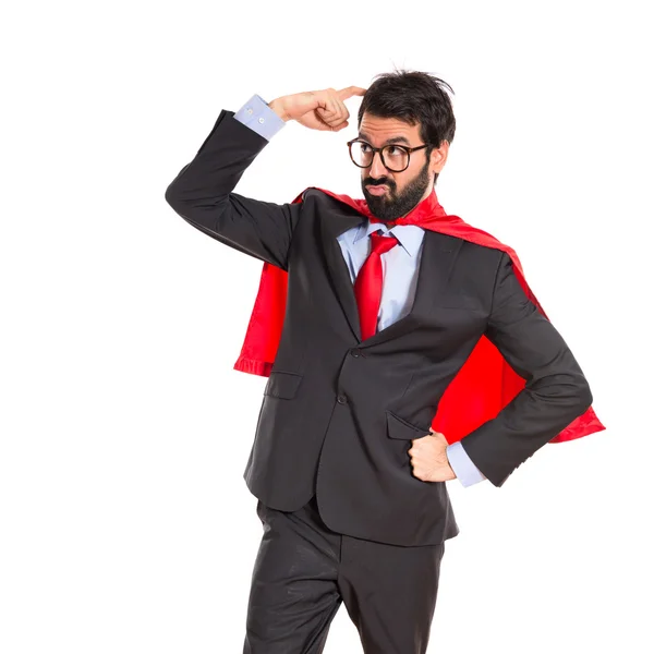 Affärsman klädd som superhjälte tänkande över vita — Stockfoto