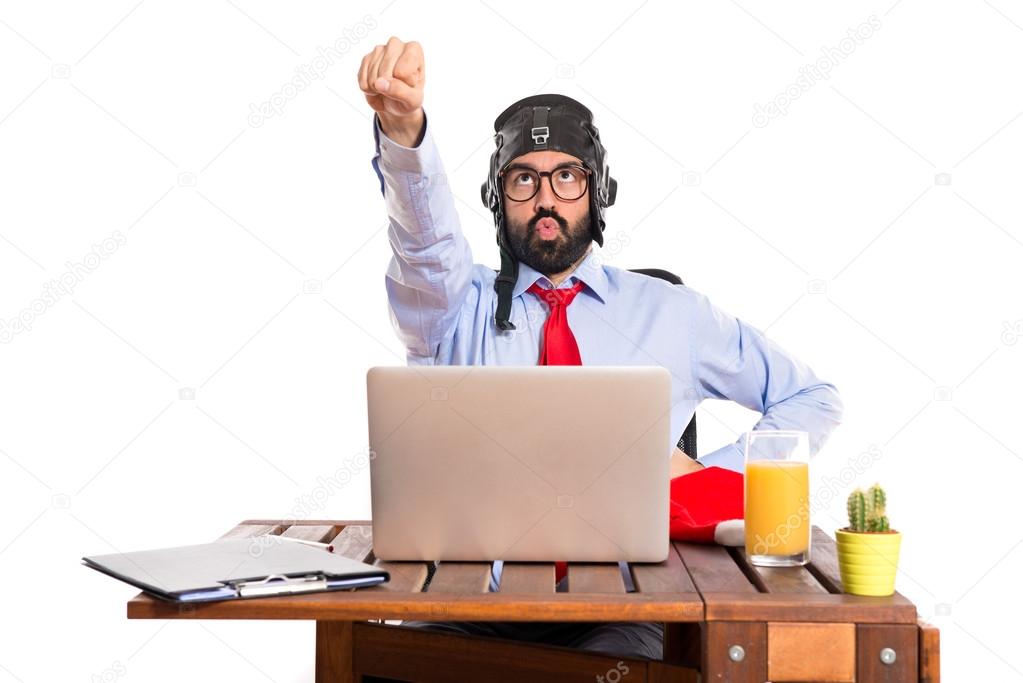 Businessman in his office with pilot hat