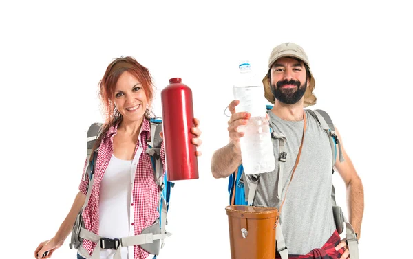 Backpacker drinking water over white background — Stock Photo, Image