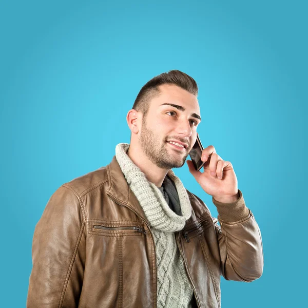 Giovani uomini d'affari che parlano con cellulare su sfondo blu . — Foto Stock