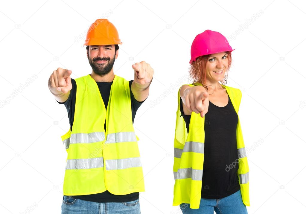 Workman pointing to the front over white background