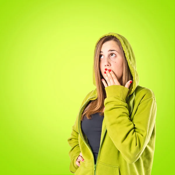 Girl doing surprise gesture over green background — Stock Photo, Image