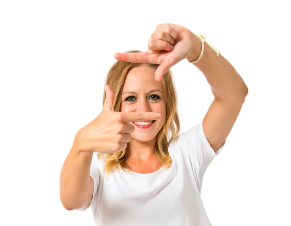 Blonde woman focusing with her fingers over white background — Stock Photo, Image