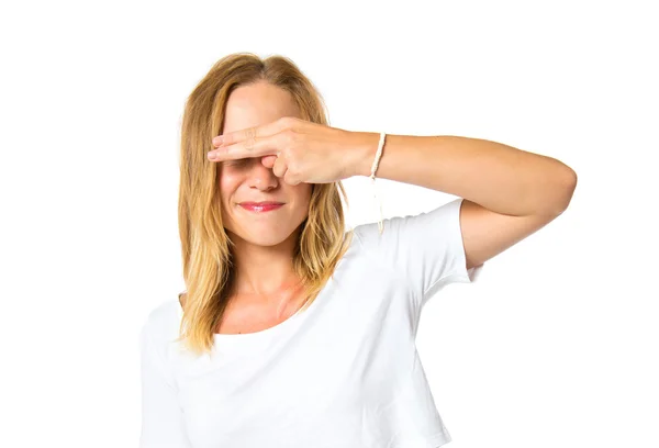 Pretty woman covering her eyes over isolated white background — Stock Photo, Image