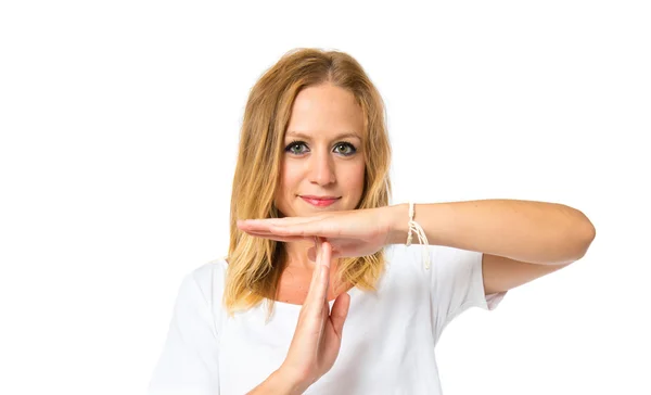 Cute blonde girl making time out gesture over white background — Stock Photo, Image