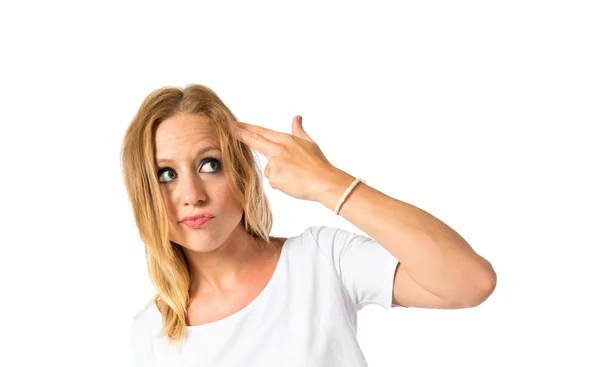 Girl making suicide gesture over white background — Stock Photo, Image
