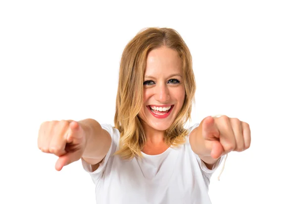 Blonde woman pointing to the front over white background — Stock Photo, Image