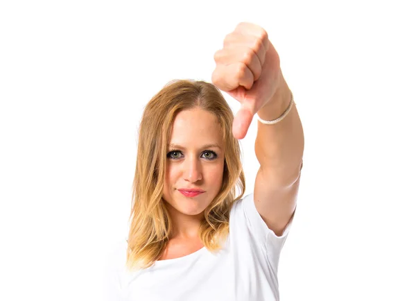 Girl doing a bad signal over white background — Stock Photo, Image
