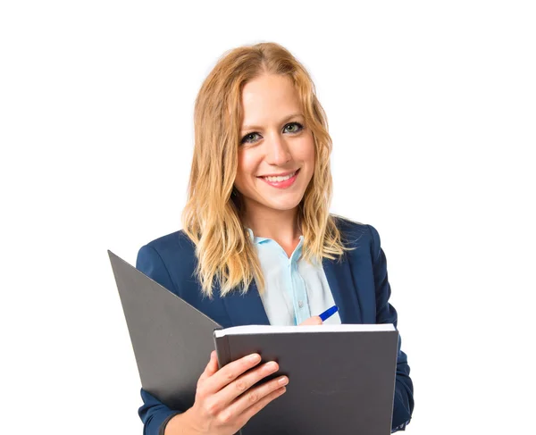 Girl writting in a book over white background — Stock Photo, Image