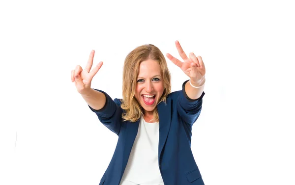 Woman doing victory gesture over white background — Stock Photo, Image