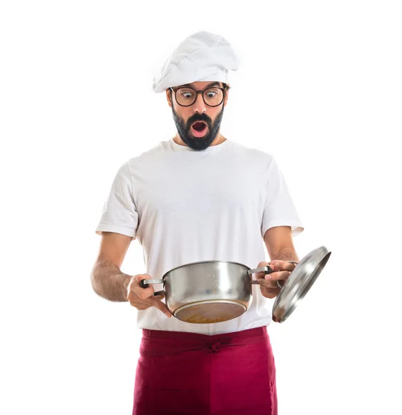 Surprisd chef looking into pot — Stock Photo, Image