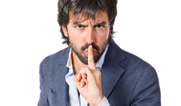 Man making silence gesture over isolated white background — Stock Photo, Image