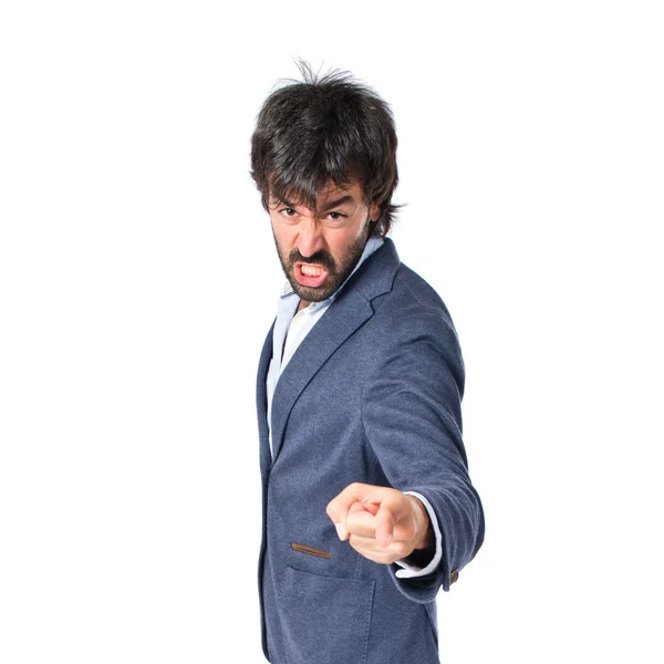 Angry man pointing somebody over isolated white background — Stock Photo, Image