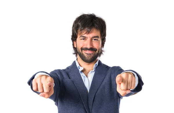 Businessman pointing to the front over white background — Stock Photo, Image