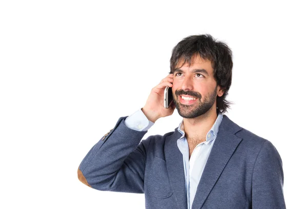 Handsome man talking to mobile over white background — Stock Photo, Image