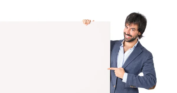 Businessman with empty placard over idolated white background — Stock Photo, Image