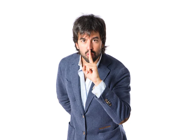 Man making silence gesture over isolated white background — Stock Photo, Image