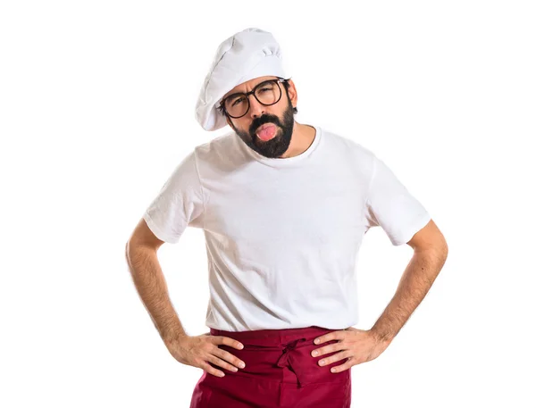 Chef doing a joke over white background — Stock Photo, Image