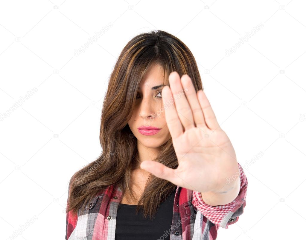 Girl making stop sign over white background