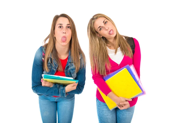 Students doing a joke over isolated white background — Stock Photo, Image