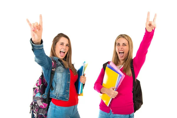 Student kvinnor gör horn gest vit bakgrund — Stockfoto