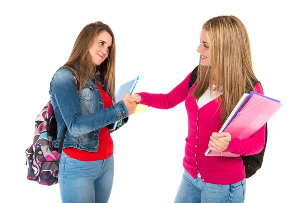 Students making a deal over isolated white background — Stock Photo, Image