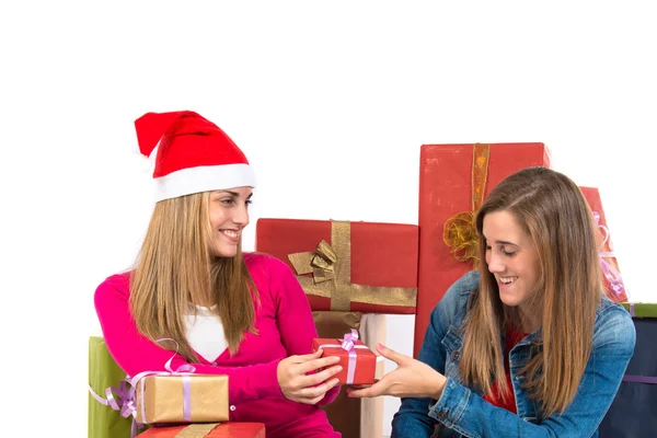 Christmas women holding gifts over white background — Stock Photo, Image