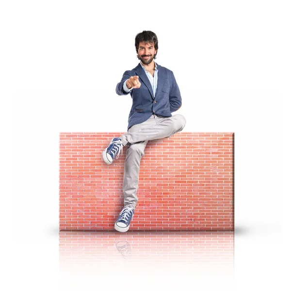 Man pointing to the front over rectangular placard — Stock Photo, Image