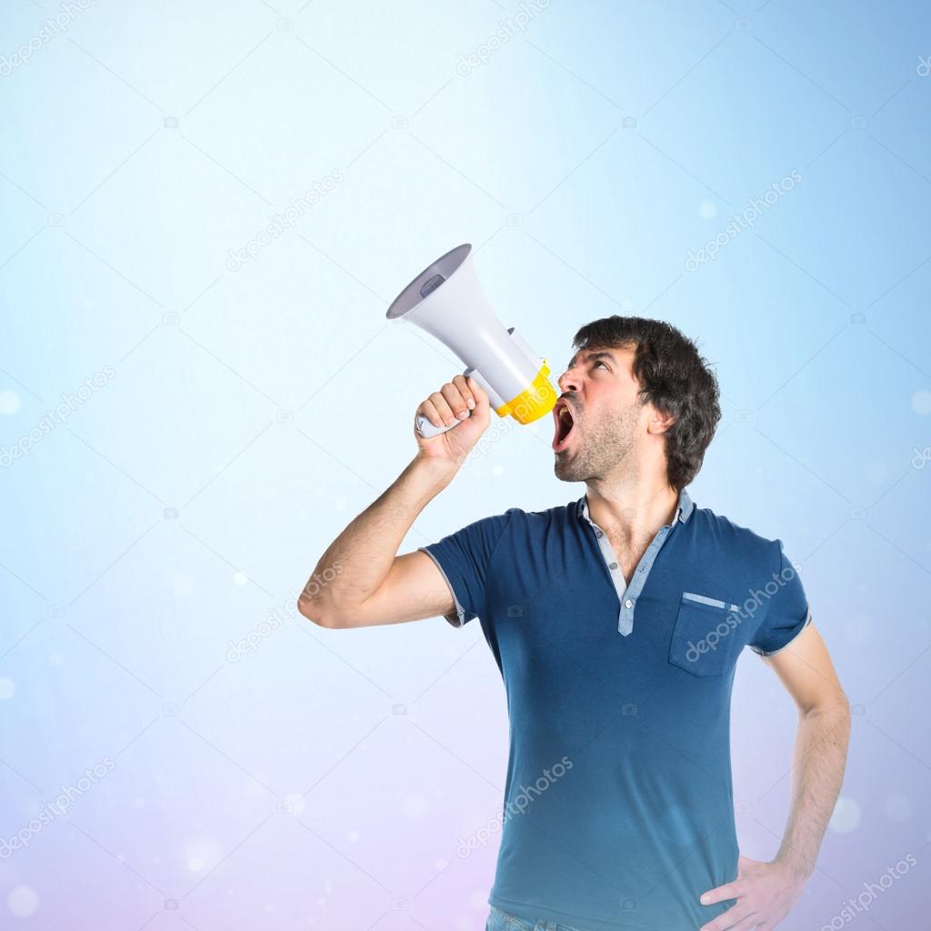 Man shouting over blue background