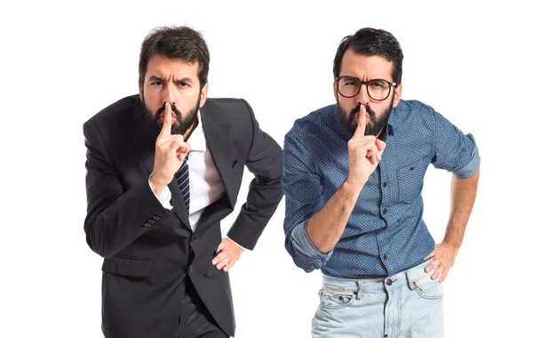 Twin brothers making silence gesture over isolated white background — Stock Photo, Image