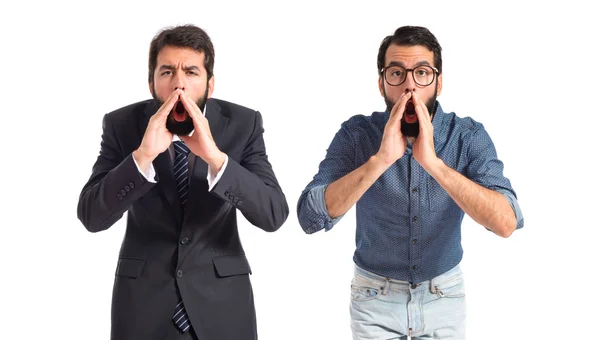 Twin brothers shouting over isolated white background — Stock Photo, Image