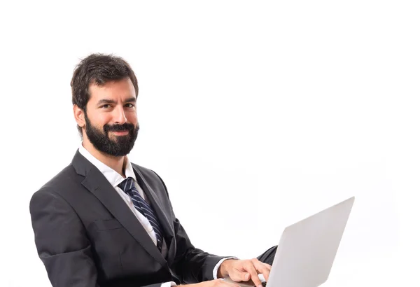 Happy businessman with laptop over isolated white background — Stock Photo, Image