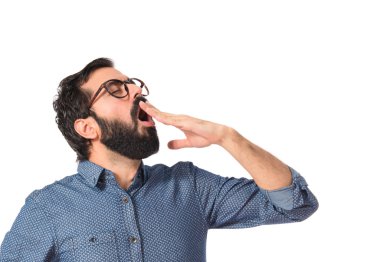 Beyaz arka plan üzerinde esneme genç hipster adam 