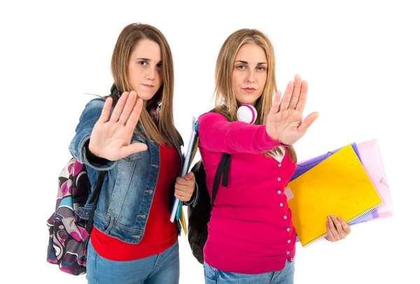 Students making stop sign over white background — Stock Photo, Image