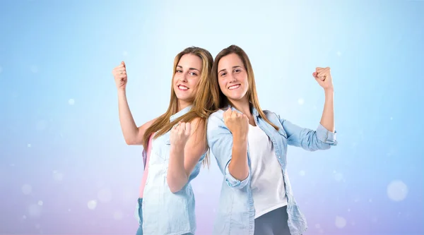 Lucky girls  over blue background — Stock Photo, Image