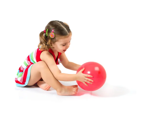 Kid playing with balloons over white background — Stock Photo, Image