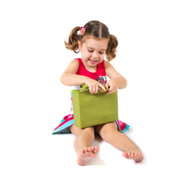 Kid holding a present over white background — Stock Photo, Image