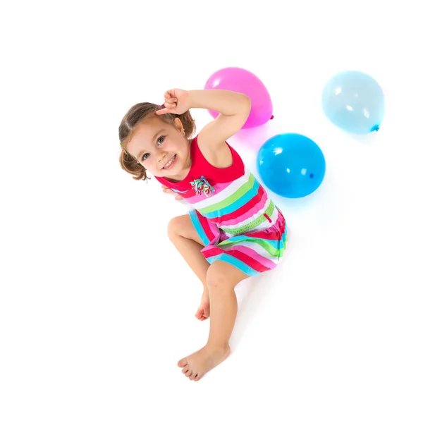 Kid playing with balloons over white background — Stock Photo, Image